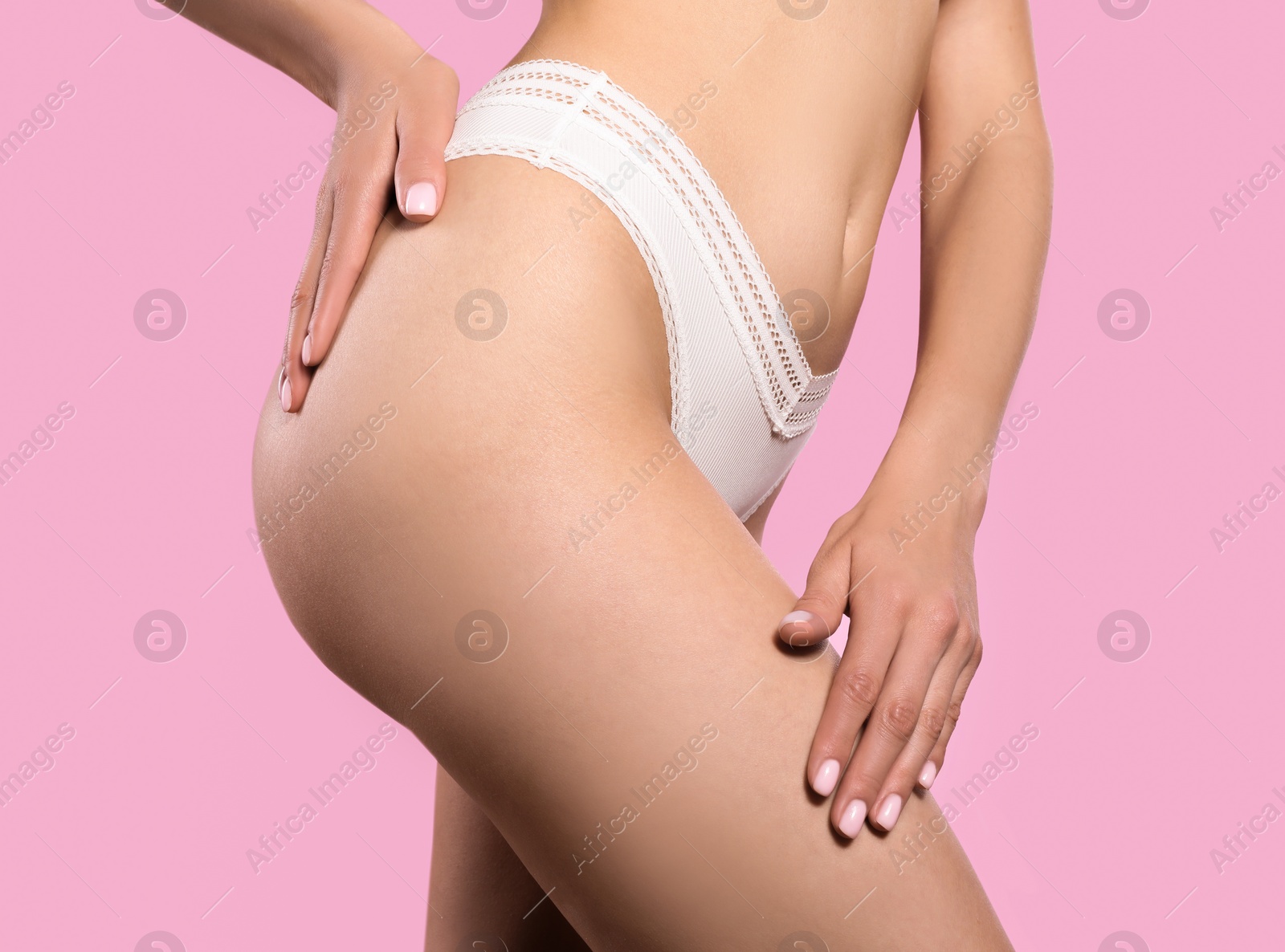 Photo of Closeup view of slim woman in underwear on pink background. Cellulite problem concept