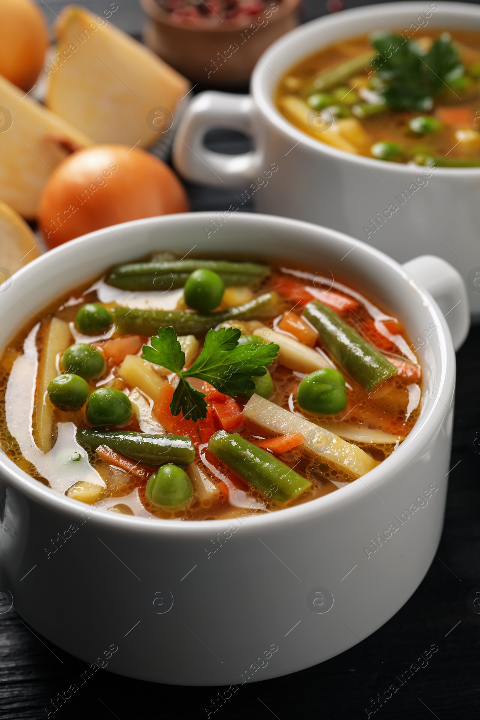 Photo of Bowls of tasty turnip soup on dark table