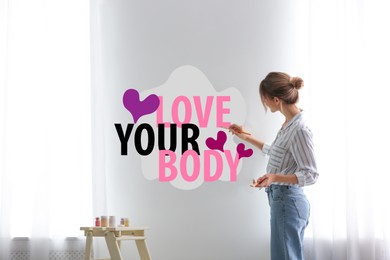Image of Woman writing words Love Your Body and drawing hearts on wall at home