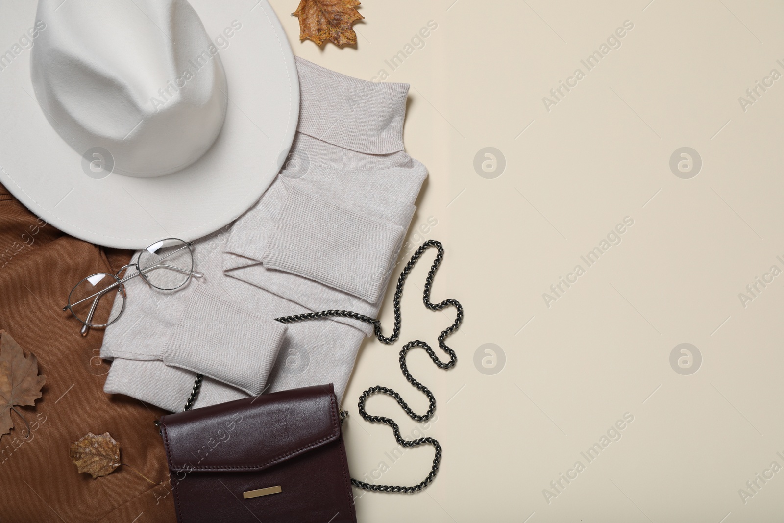Photo of Flat lay composition with stylish hat and clothes on beige background, space for text