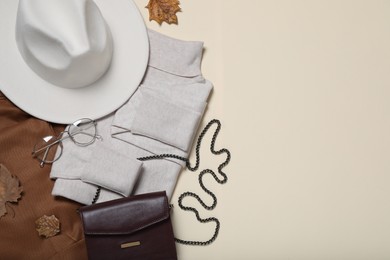 Flat lay composition with stylish hat and clothes on beige background, space for text