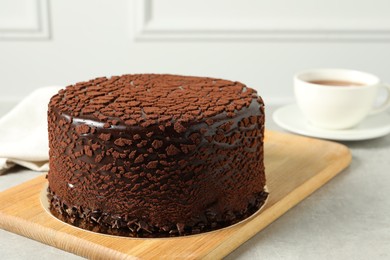 Photo of Delicious chocolate truffle cake on light grey table