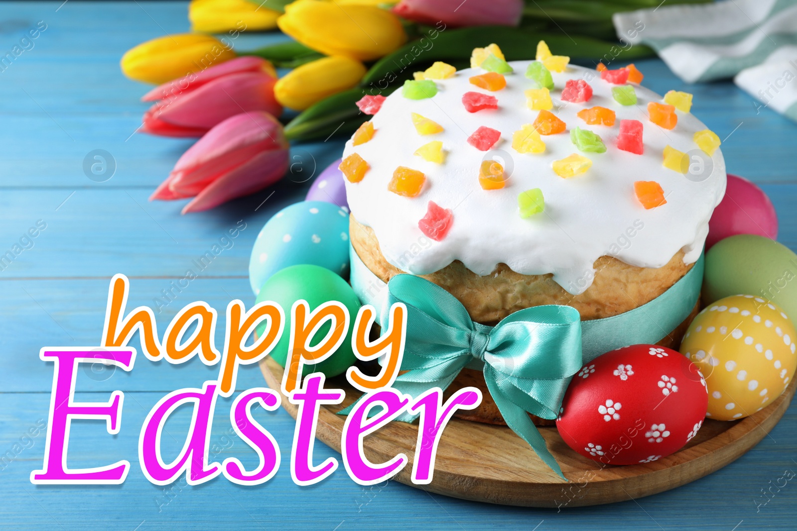 Image of Happy holiday. Easter cake, color eggs and tulips on blue wooden table
