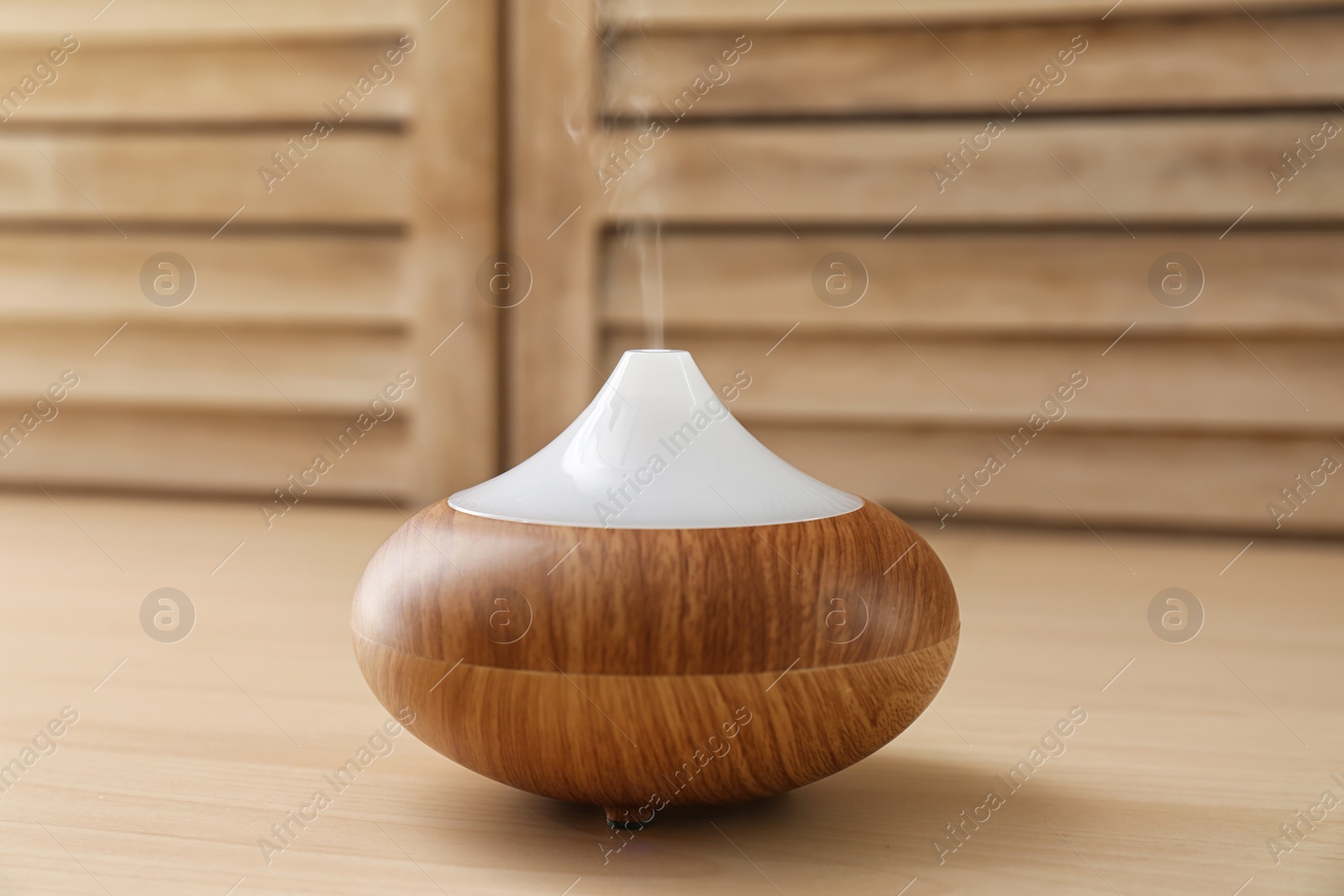 Photo of Modern aroma lamp on wooden table