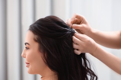 Photo of Hair styling. Professional hairdresser working with client indoors, closeup