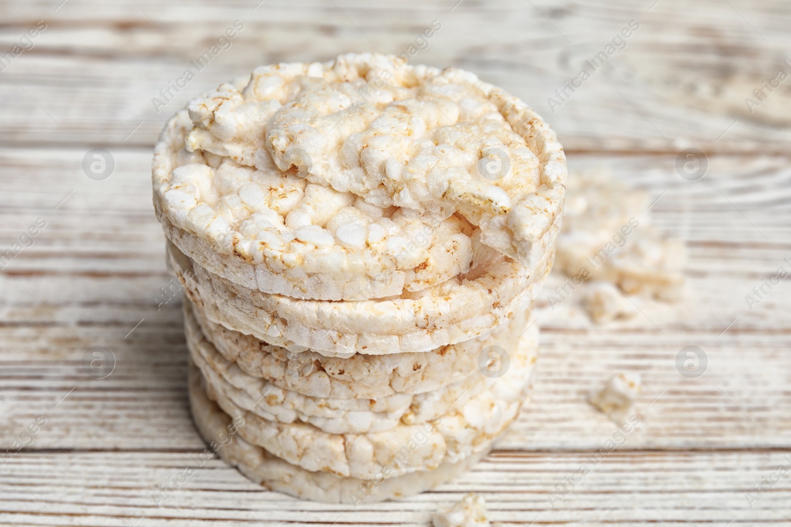 Photo of Stack of puffed rice cakes on white wooden table