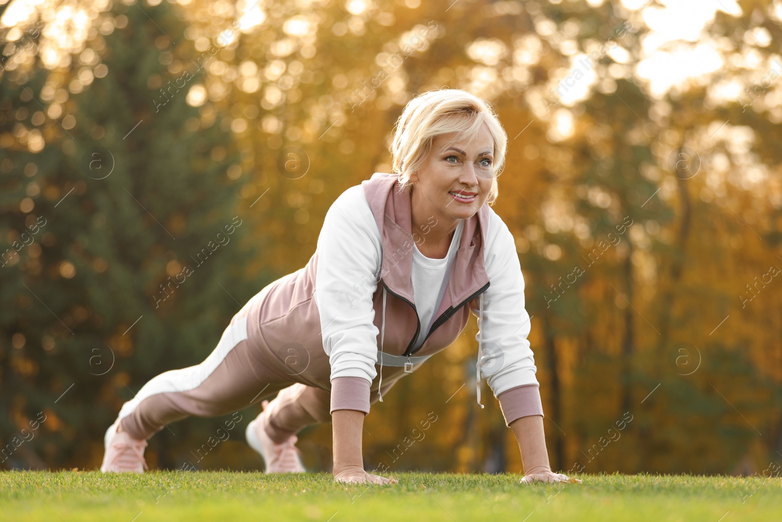 Photo of Mature woman doing exercise in park. Active lifestyle