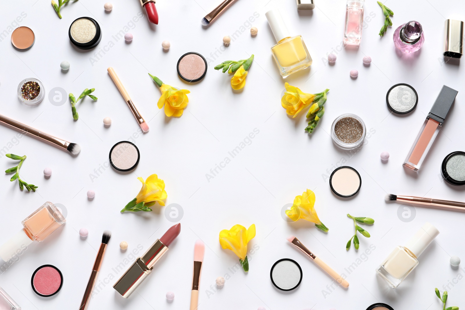 Photo of Different makeup products and flowers on white background, top view with space for text