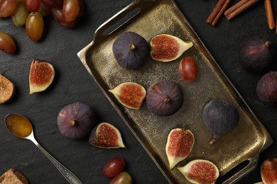Photo of Flat lay composition with ripe figs on black slate table