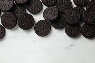 Tasty sandwich cookies on white marble table, flat lay. Space for text