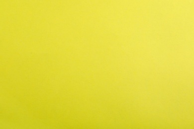 Photo of Abstract yellow background, top view. Colorful paper