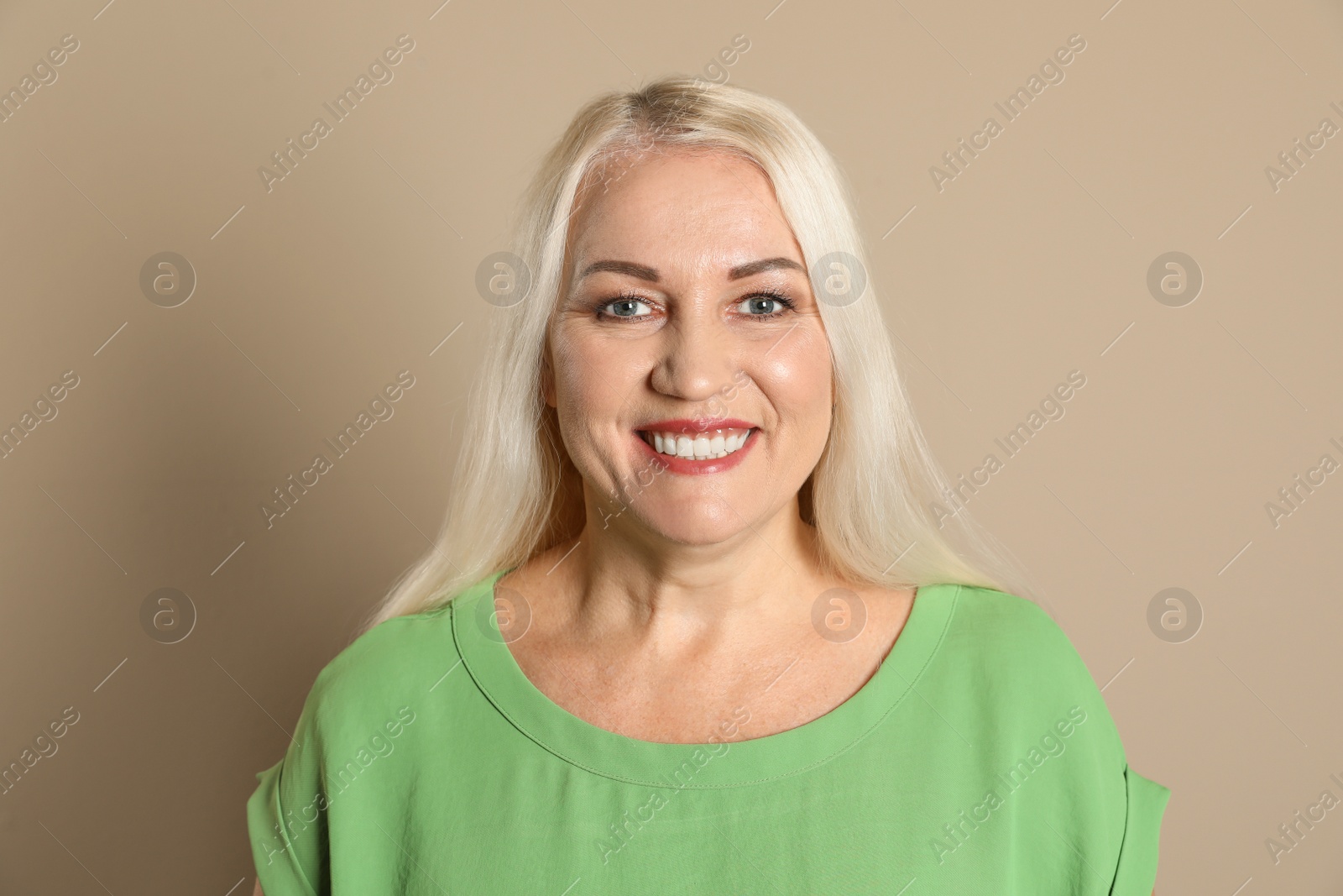 Photo of Smiling woman with perfect teeth on color background