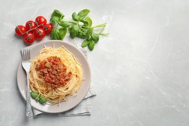 Photo of Flat lay composition with delicious pasta bolognese on light background