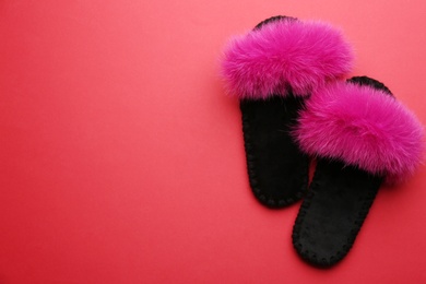 Photo of Pair of soft slippers on red background, flat lay. Space for text