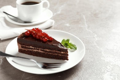 Slice of tasty chocolate cake with berries served on table. Space for text