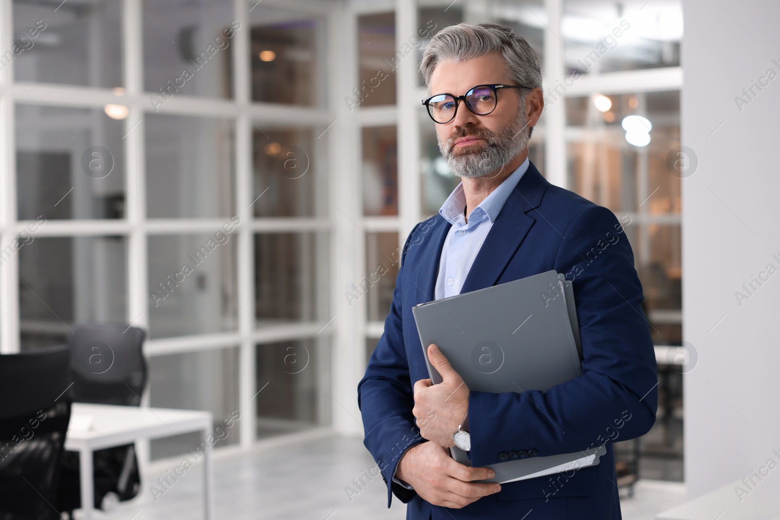 Photo of Portrait of handsome man with folder in office, space for text. Lawyer, businessman, accountant or manager