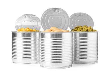 Photo of Open tin cans of peas, beans and corn kernels isolated on white