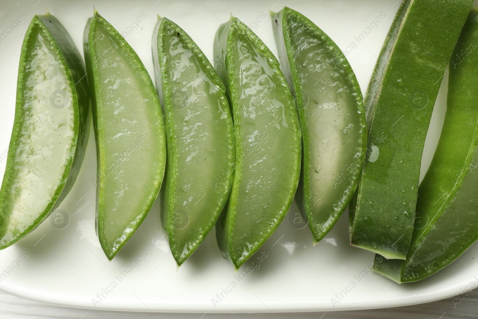 Photo of Fresh aloe vera slices on table, top view
