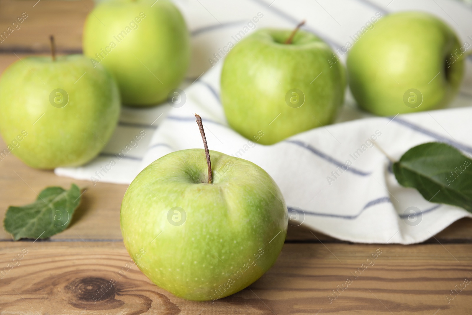 Photo of Fresh ripe green apples on wooden table, space for text