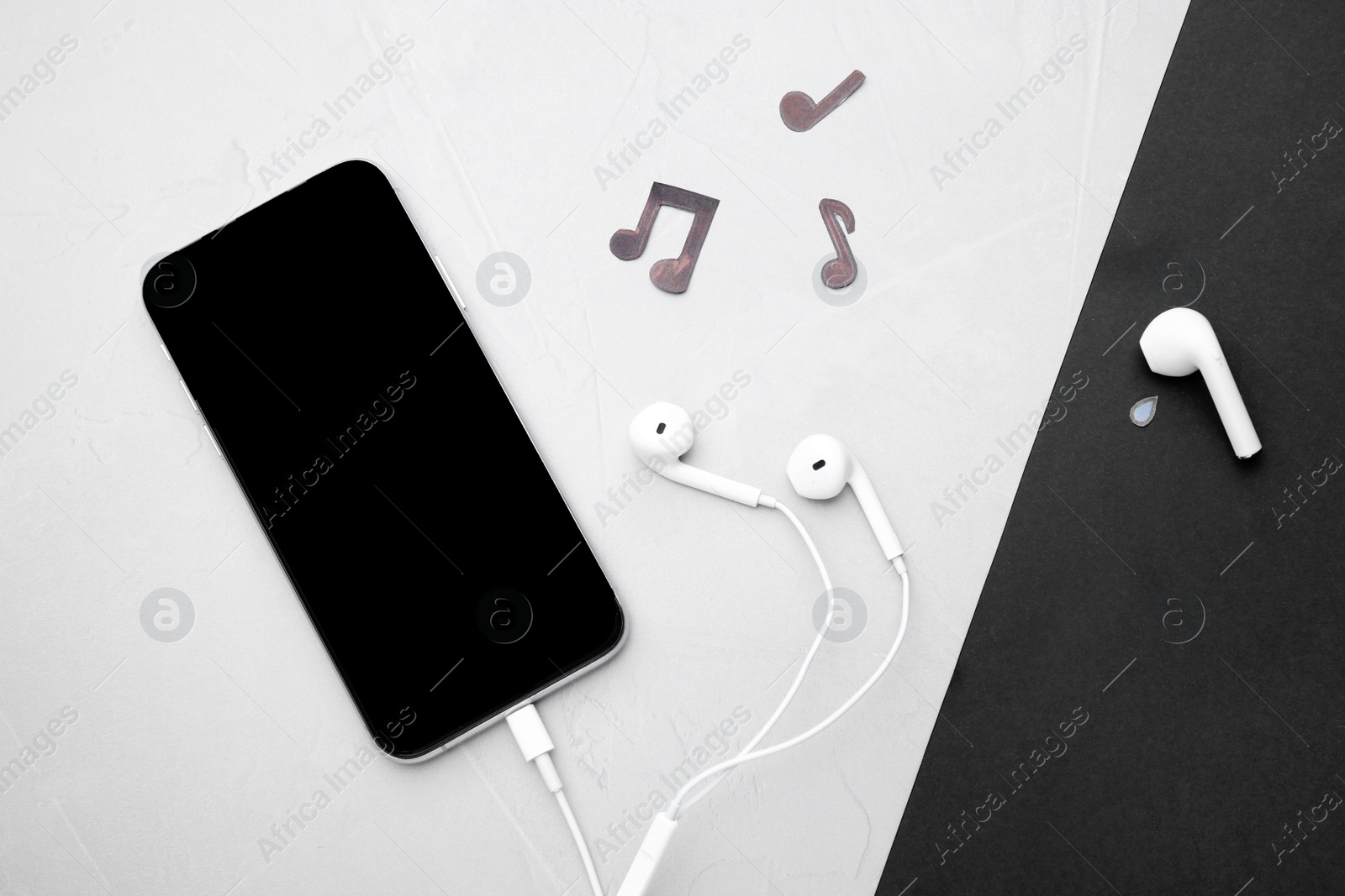 Photo of Smartphone and earphones on color background, flat lay. Concept of jealousy