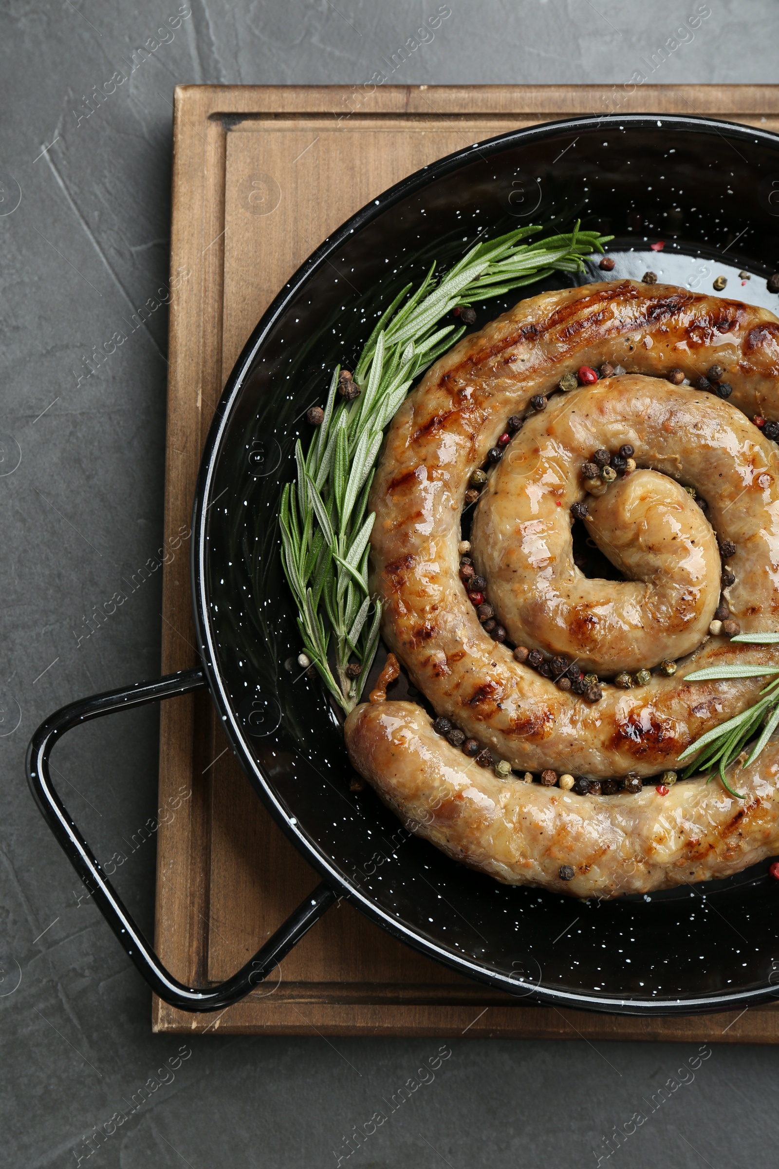 Photo of Tasty homemade sausages with spices on grey table, top view