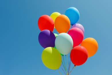 Bunch of colorful balloons against blue sky