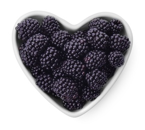 Photo of Heart shaped bowl of tasty blackberries on white background, top view