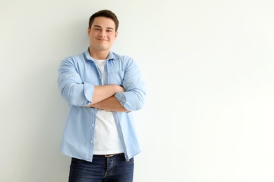 Photo of Portrait of confident young man on light background