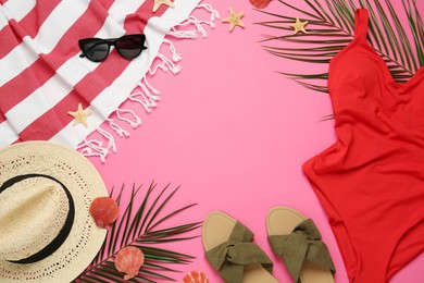 Photo of Frame made with different beach objects on pink background, flat lay. Space for text