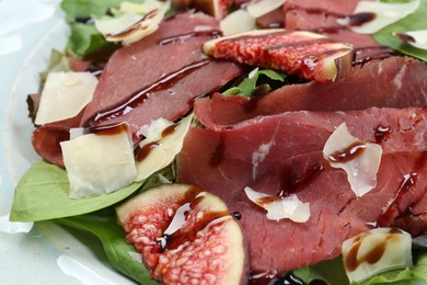 Photo of Delicious bresaola salad on plate, closeup view
