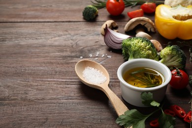 Fresh products on wooden table, space for text. Healthy cooking