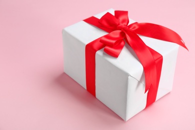 Photo of Beautifully decorated gift box on color background