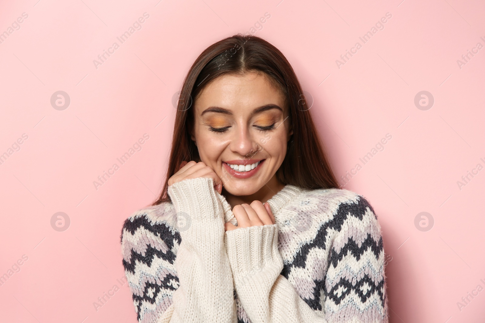 Photo of Beautiful young woman in warm sweater on color background