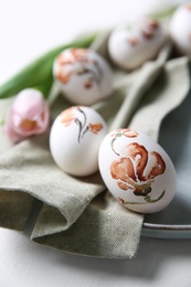 Photo of Beautifully painted Easter eggs on plate, closeup