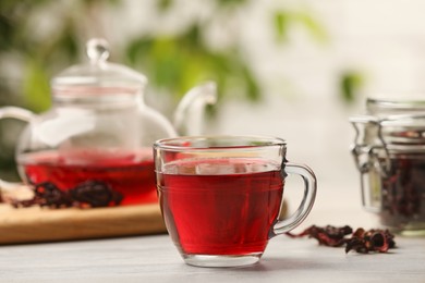 Photo of Delicious hibiscus tea on white wooden table