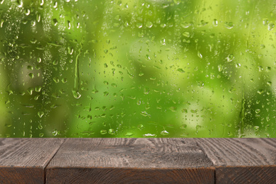 Wooden table near window on rainy day