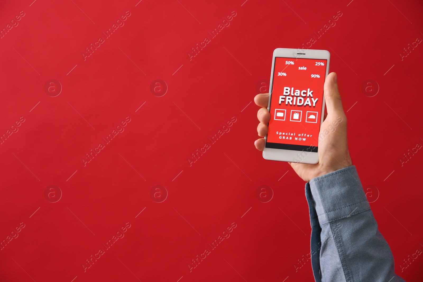 Photo of Man shopping online using smartphone on red background, space for text. Black Friday Sale