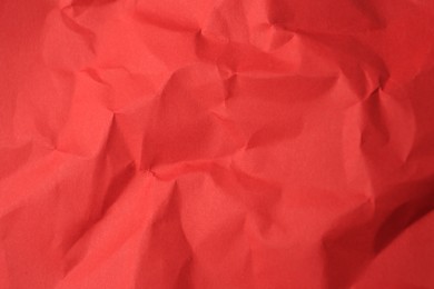 Photo of Sheet of crumpled red paper as background, top view