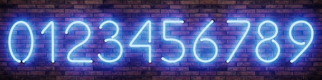 Image of Glowing neon number signs on brick wall