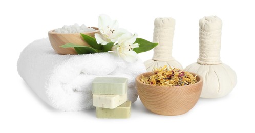 Photo of Spa composition. Towel, herbal massage bags, sea salt, soap and dry flowers on white background