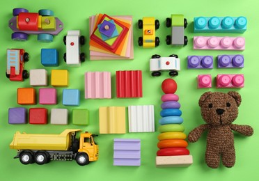 Photo of Different children's toys on green background, flat lay
