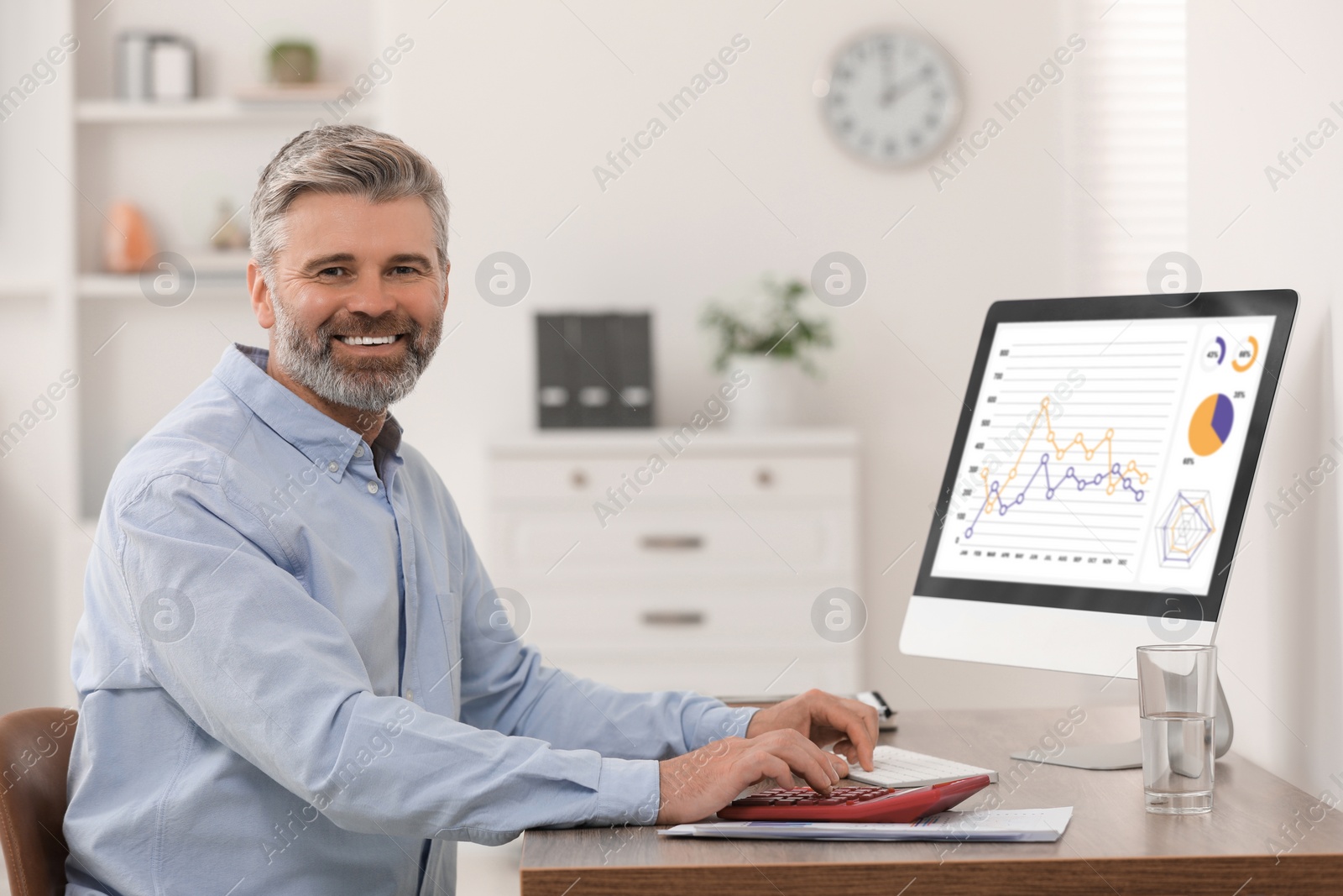 Photo of Professional accountant working at wooden desk in office