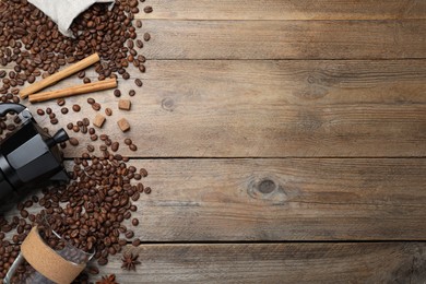 Photo of Flat lay composition with roasted coffee beans on wooden table. Space for text