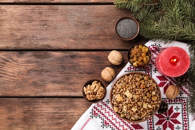 Photo of Traditional Christmas slavic dish kutia served on wooden table, flat lay. Space for text