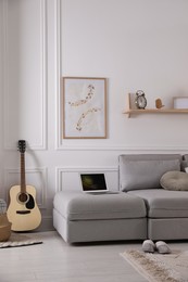 Photo of Living room with comfortable grey sofa and stylish interior elements