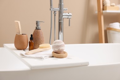 Different personal care products and accessories on bath tub in bathroom