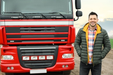 Photo of Portrait of driver at modern truck outdoors