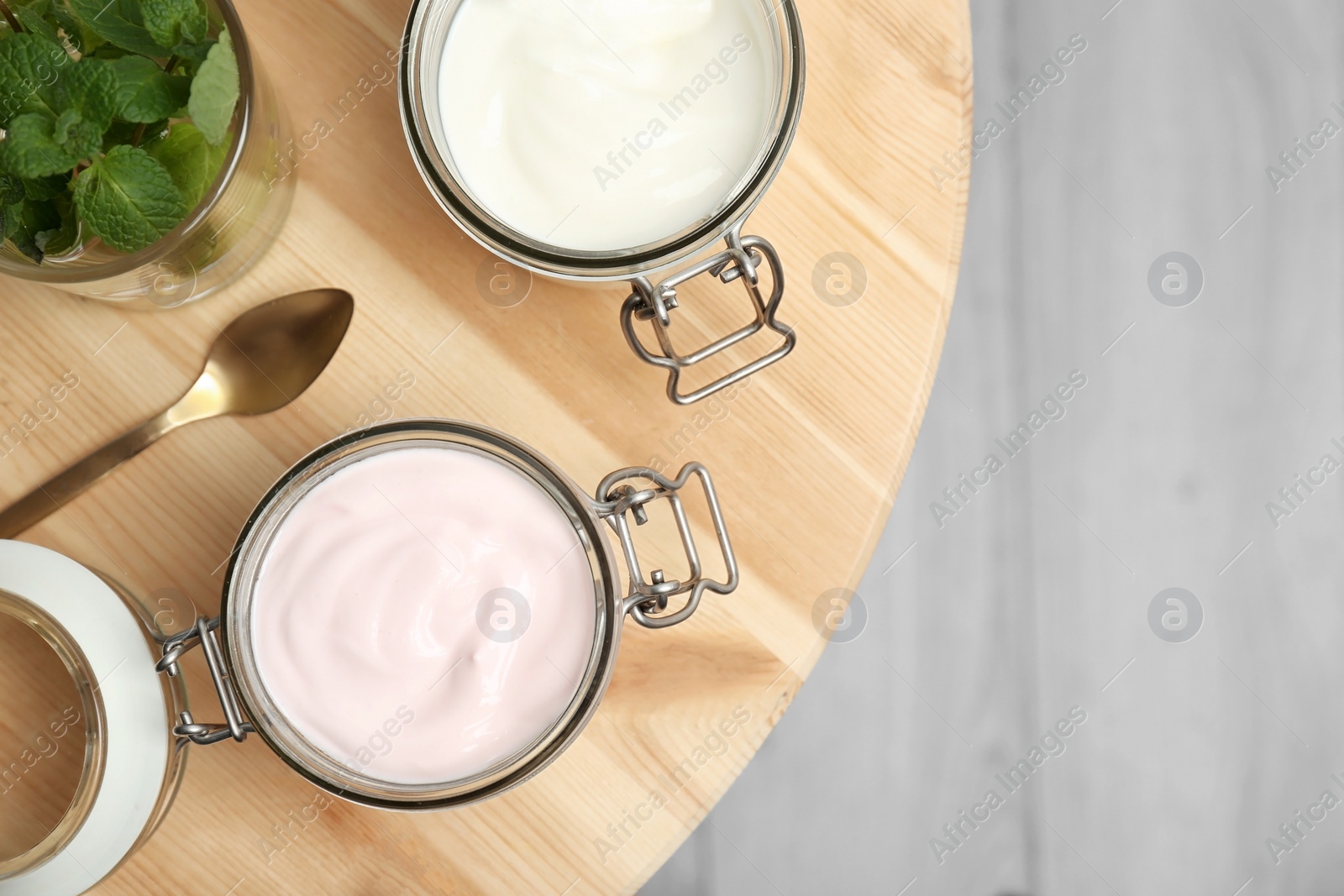 Photo of Jars with different yogurts on table