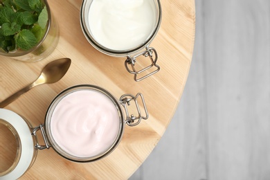 Photo of Jars with different yogurts on table