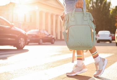 Young woman with stylish turquoise bag on city street, closeup